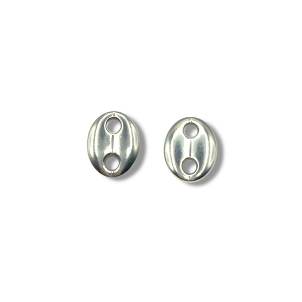 Two silver oval beads with holes on a white background