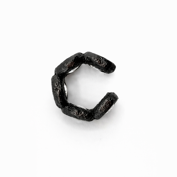 Black metal clip on a white background
