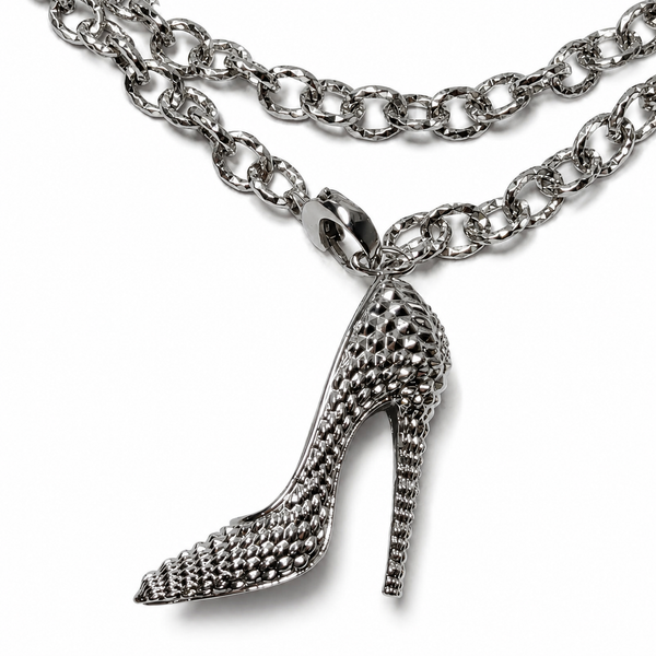 Close-up of the I’M BAD engraving inside the stiletto heel pendant