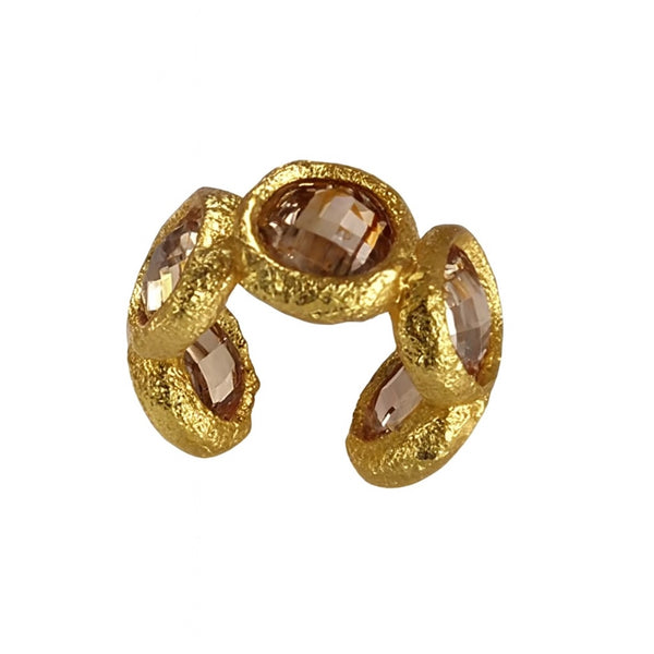 Gold ring with embedded stones on a white background