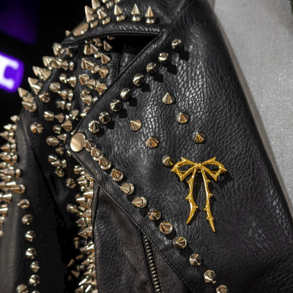 Carrie now brooch on a black leather jacket by jagged halo jewelry