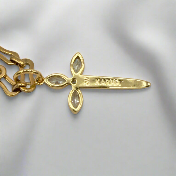Gold bracelet with a unique pendant on a light gray background
