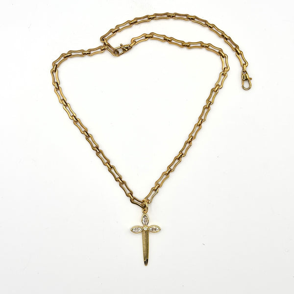 Gold chain necklace with a sword-shaped pendant on a white background