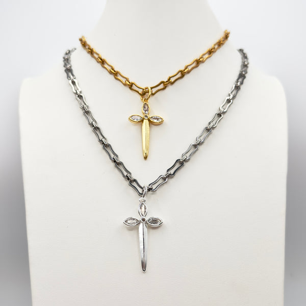 Two necklaces with sword pendants on a mannequin bust against a white background