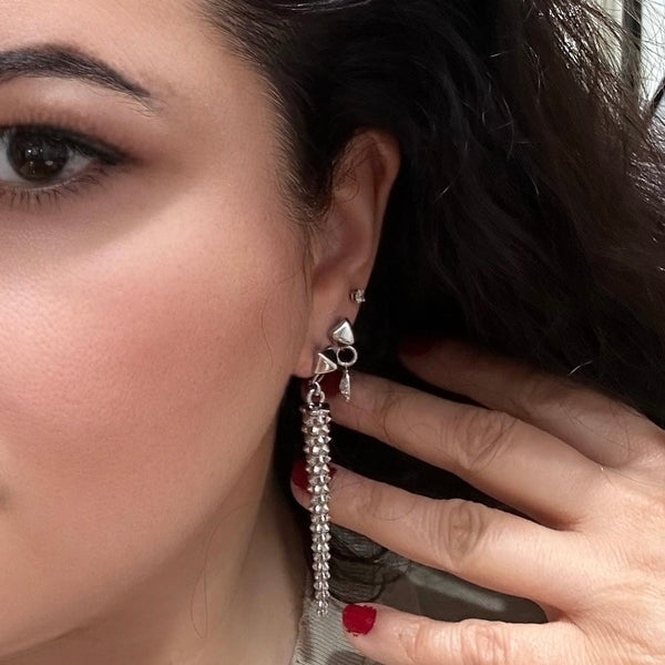 silver ear stack with Pair of long, silver studded drop earrings with a bold pyramid stud top, perfect for adding edgy elegance to any look.