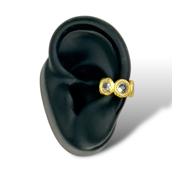yellow gold sterling silver crystal ear cuff agains a black ear form