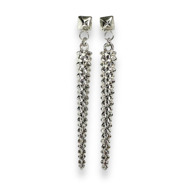 Pair of long, white gold silver studded drop earrings with a bold pyramid stud top, perfect for adding edgy elegance to any look.