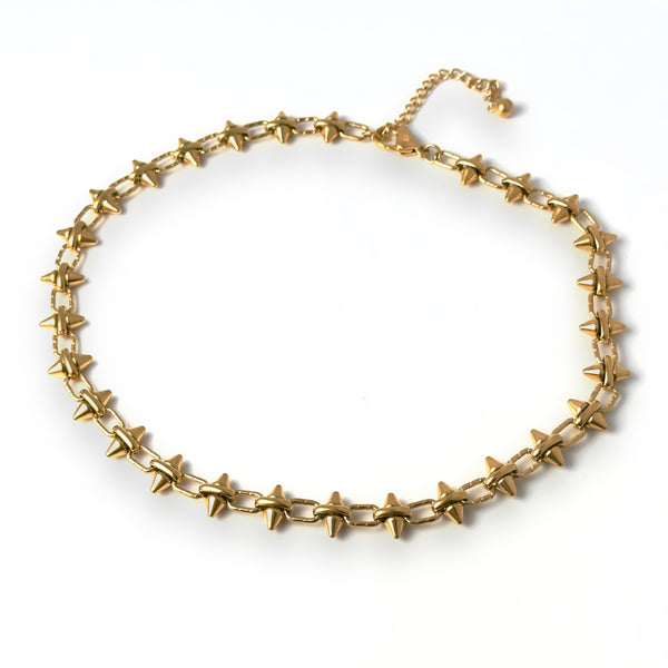 A gold-tone Barbie Chain Necklace with a spiky chain design, displayed against a white background.