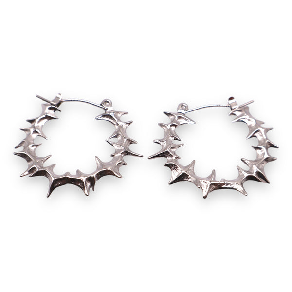 A pair of gold-colored Yennefer spike hoop earrings with an organic edgy spiked outer layer on a white background.