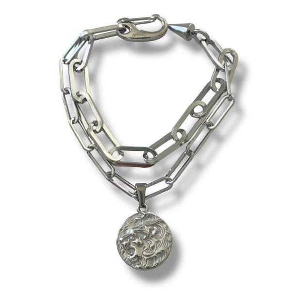 Silver chain bracelet with a round pendant on a white background