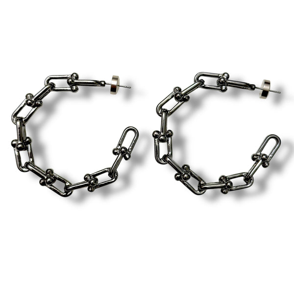 Pair of chain-link hoop earrings on a white background