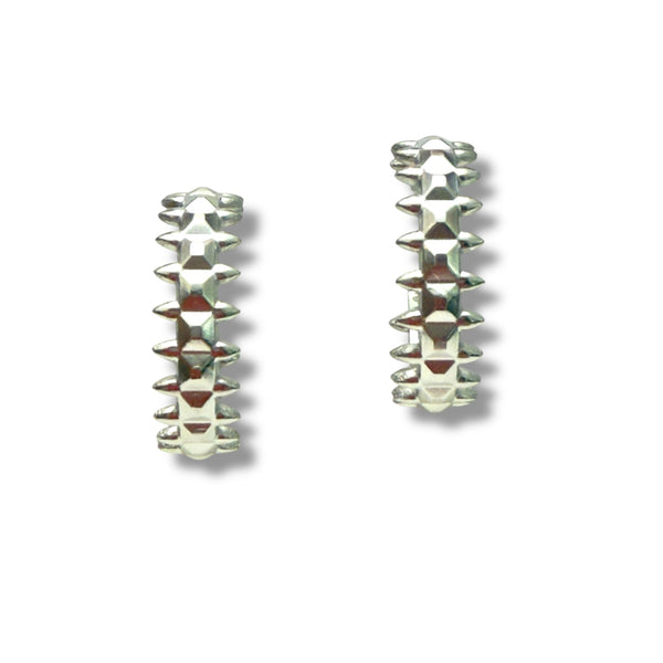 Pair of silver spike earrings on a white background