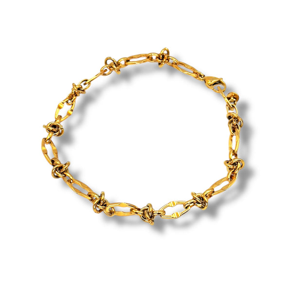 Gold chain bracelet on a white background