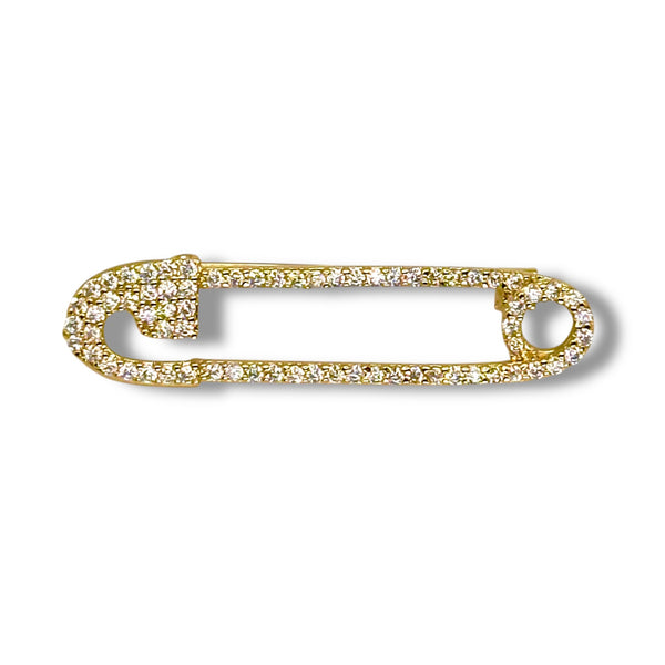 Gold safety pin with gemstones on a white background