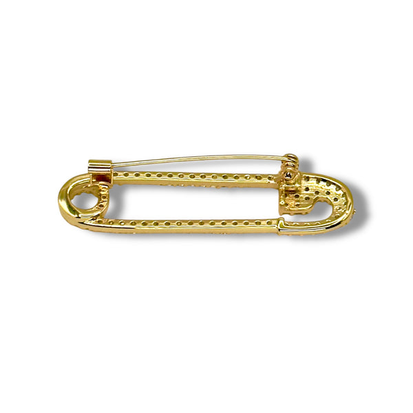 Gold safety pin brooch on a white background