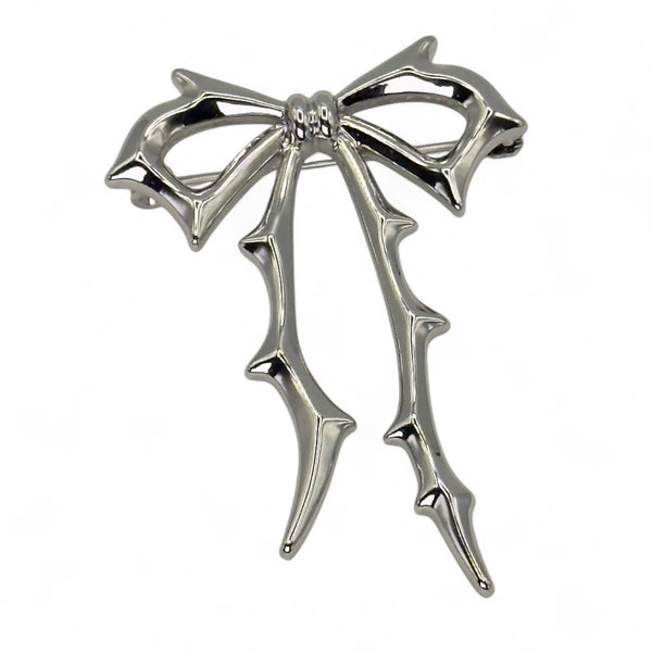 Carrie Bow Brooch in yellow gold with stainless-steel base and gold-filled bow design by Jagged Halo Jewelry.