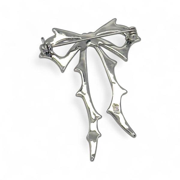 Carrie Bow Brooch in yellow gold with stainless-steel base and gold-filled bow design by Jagged Halo Jewelry.