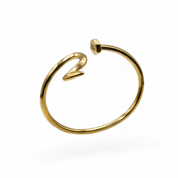 Gold nail bracelet on a white background