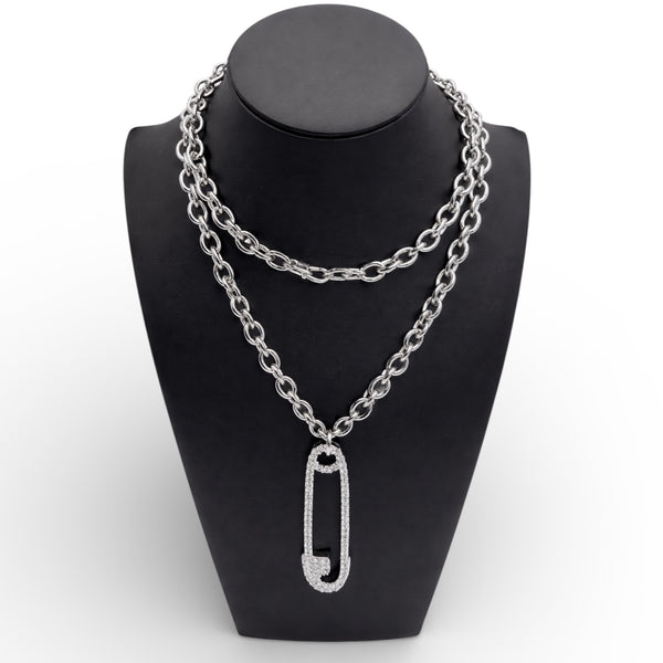 Silver chain necklace with a unique pendant on a black mannequin bust.