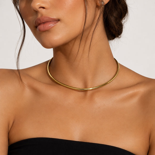 yellow gold plated stainless steel collar necklace choker jagged halo jewelry worn by brunette model wearing black strapless dress