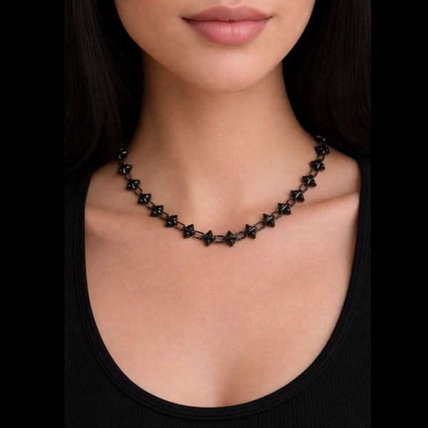 hematite plated stainless steel barbie chain necklace by jagged halo jewelry star-shaped necklace worn by a model on a black background