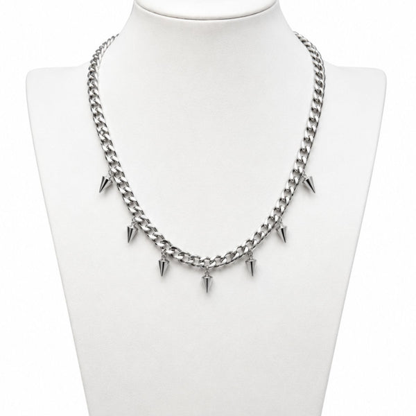 Silver chain necklace with spike-like pendants on a mannequin bust.