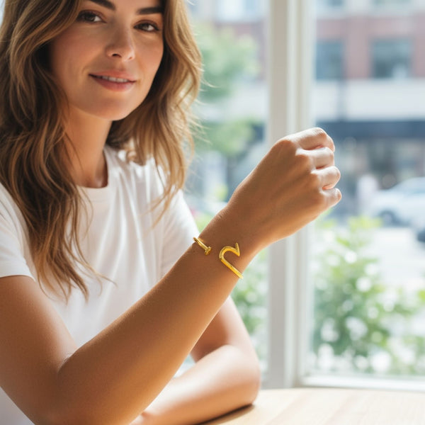Woman wearing a yellow bracelet with a heart design indoors
