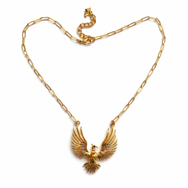 Gold necklace with an eagle pendant on a white background