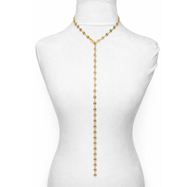 Gold necklace on a mannequin with a white background