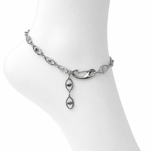 Silver anklet with a dangling heart charm on a white background