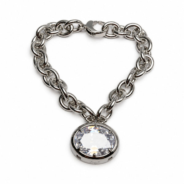 A silver-toned chain bracelet with a heart-shaped arrangement and a large round clear crystal pendant in a bezel setting, shown on a plain white background.