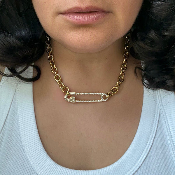 gold safety pin necklace on brunette model