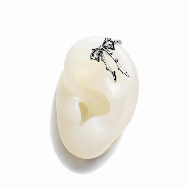 Pearl necklace with a silver bow clasp on a white background