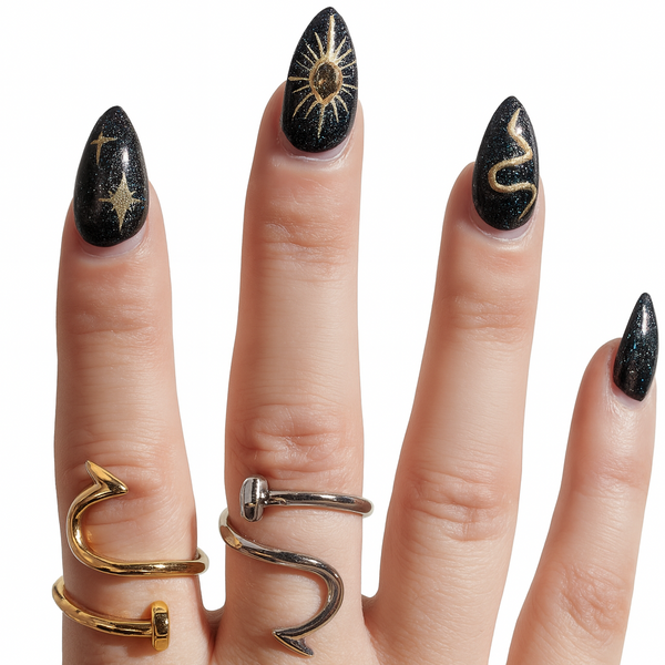 Hand with gold and silver nail ring nail jewelry juste clou ring on a white background