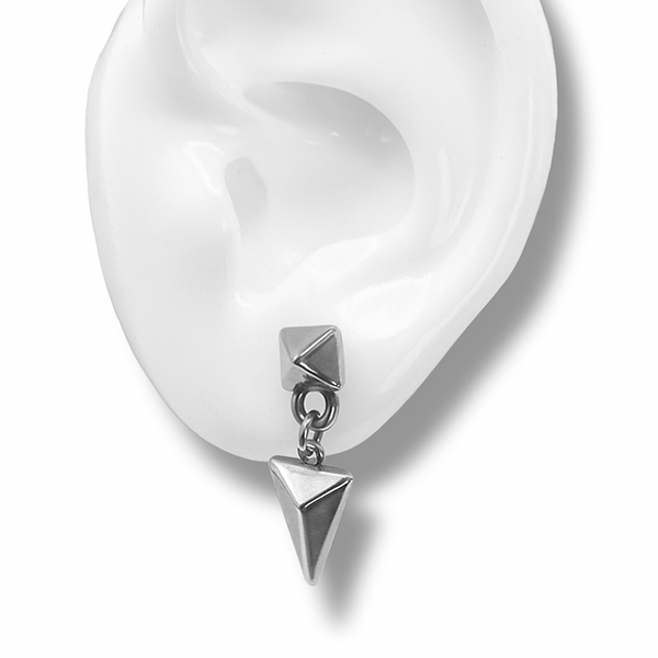 arrowhead drop earrings in silver on a white ear 