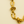 Gold chain bracelet on a beige background