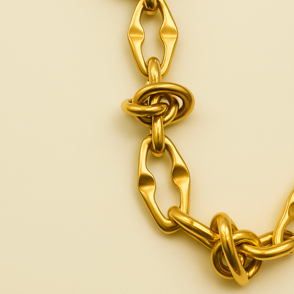 Gold chain bracelet on a beige background