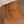 Gold chain bracelet on a wrist with a neutral background