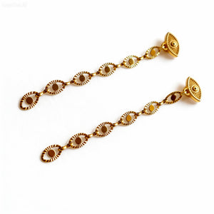 Gold bracelet with decorative links on a white background