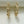 Gold chain-style earrings on a white background