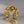 Gold ring with embedded stones on a reflective surface
