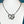 silver large snake pendant necklace with crystal eyes turquoise blue background 