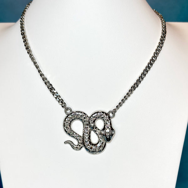 silver large snake pendant necklace with crystal eyes turquoise blue background 