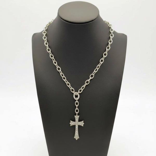 Silver chain necklace with a cross pendant on a black mannequin bust. saints cross by jagged halo jewelry