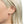 blonde model wearing spike diamond stud earrings jagged halo jewelry 