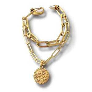 Gold chain necklace with a pendant on a white background