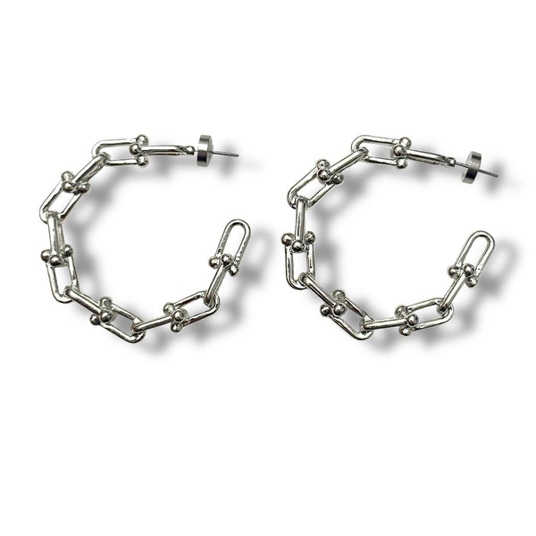 Pair of silver chain hoop earrings on a white background