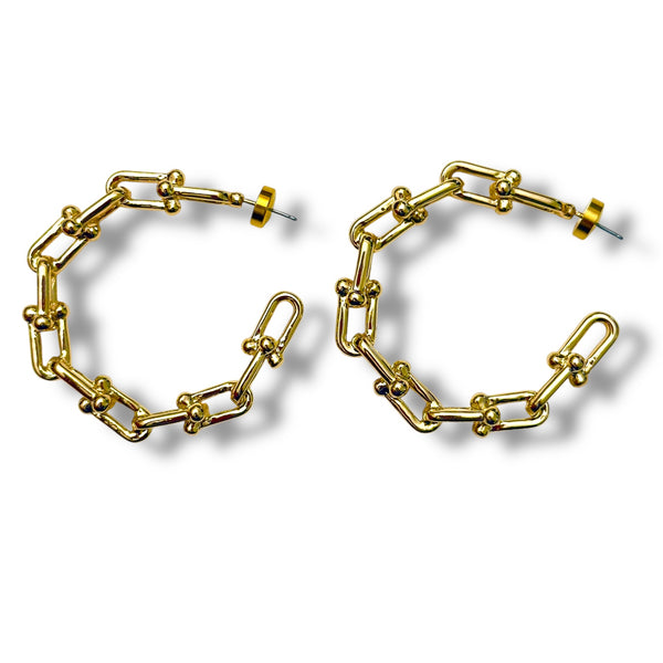 Gold chain-style hoop earrings on a white background