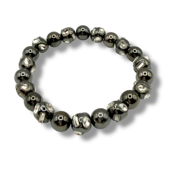 Beaded bracelet with alternating dark and light beads on a white background