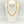 Gold chain necklace on a white mannequin bust against a light gray background